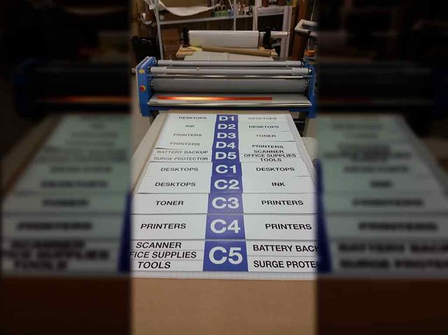 Laminated signs fresh off the laminator